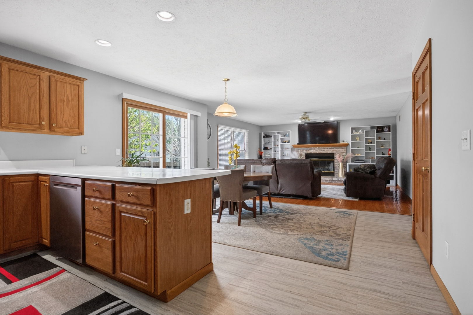 1503 Broad Creek Road Bloomington, IL 61704 - Photo 11 of 31 a kitchen with stainless steel appliances granite countertop a stove top oven a sink dishwasher and a fireplace with wooden floor