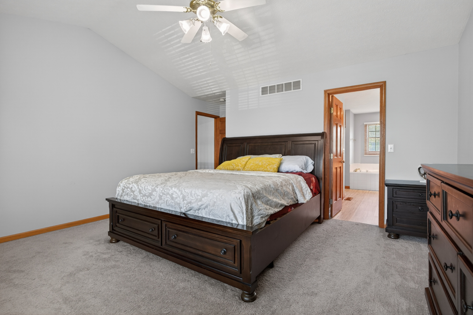 1503 Broad Creek Road Bloomington, IL 61704 - Photo 17 of 31 a spacious bedroom with a bed and a chandelier