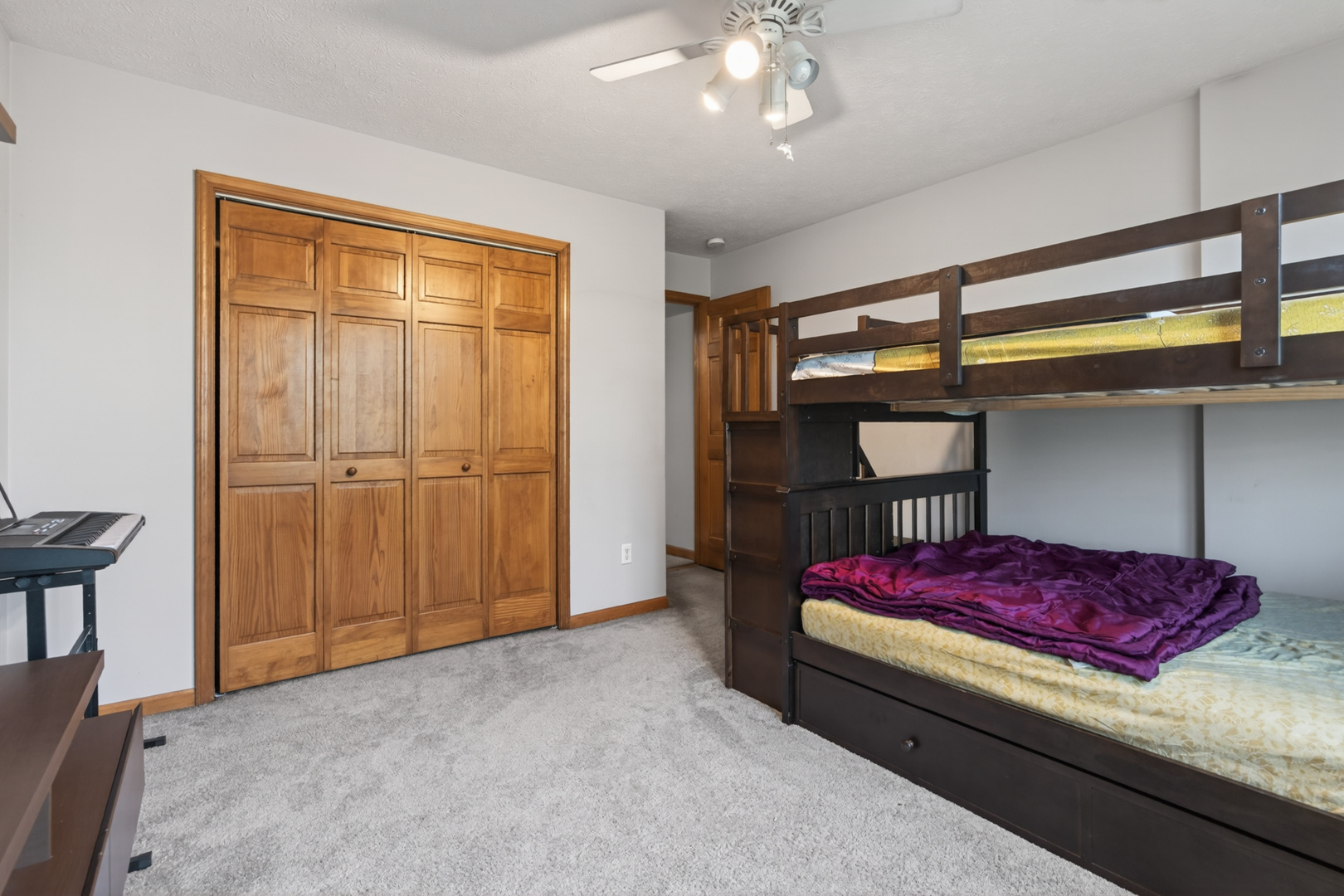 1503 Broad Creek Road Bloomington, IL 61704 - Photo 20 of 31 a bedroom with a bed and a chandelier