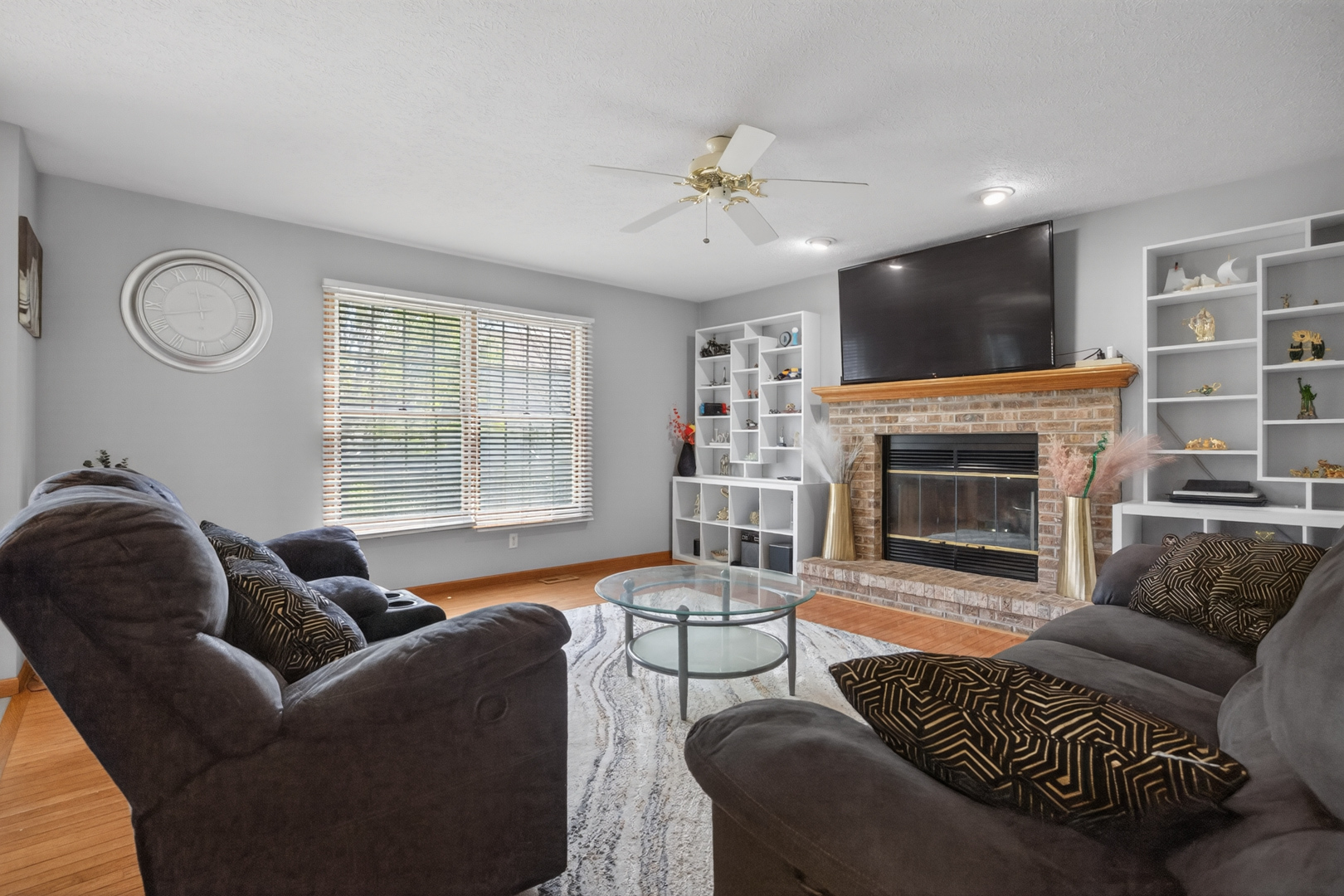 1503 Broad Creek Road Bloomington, IL 61704 - Photo 5 of 31 a living room with furniture a fireplace and a flat screen tv