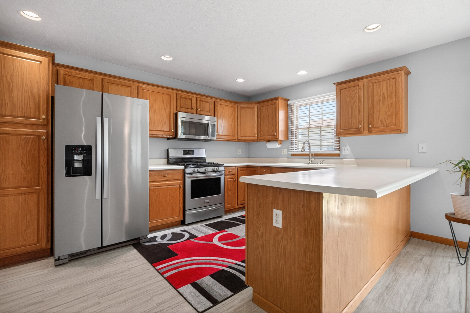 1503 Broad Creek Road Bloomington, IL 61704 - Photo 10 of 31 a kitchen with stainless steel appliances granite countertop a refrigerator a sink dishwasher a oven with large countertops with wooden floor