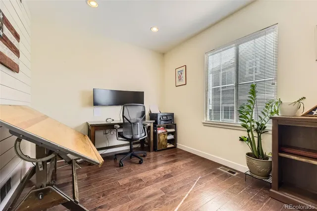 a view of a workspace with furniture and a window