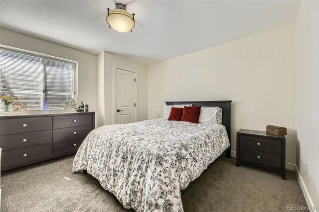 a bathroom with a granite countertop sink toilet a mirror a vanity and shower