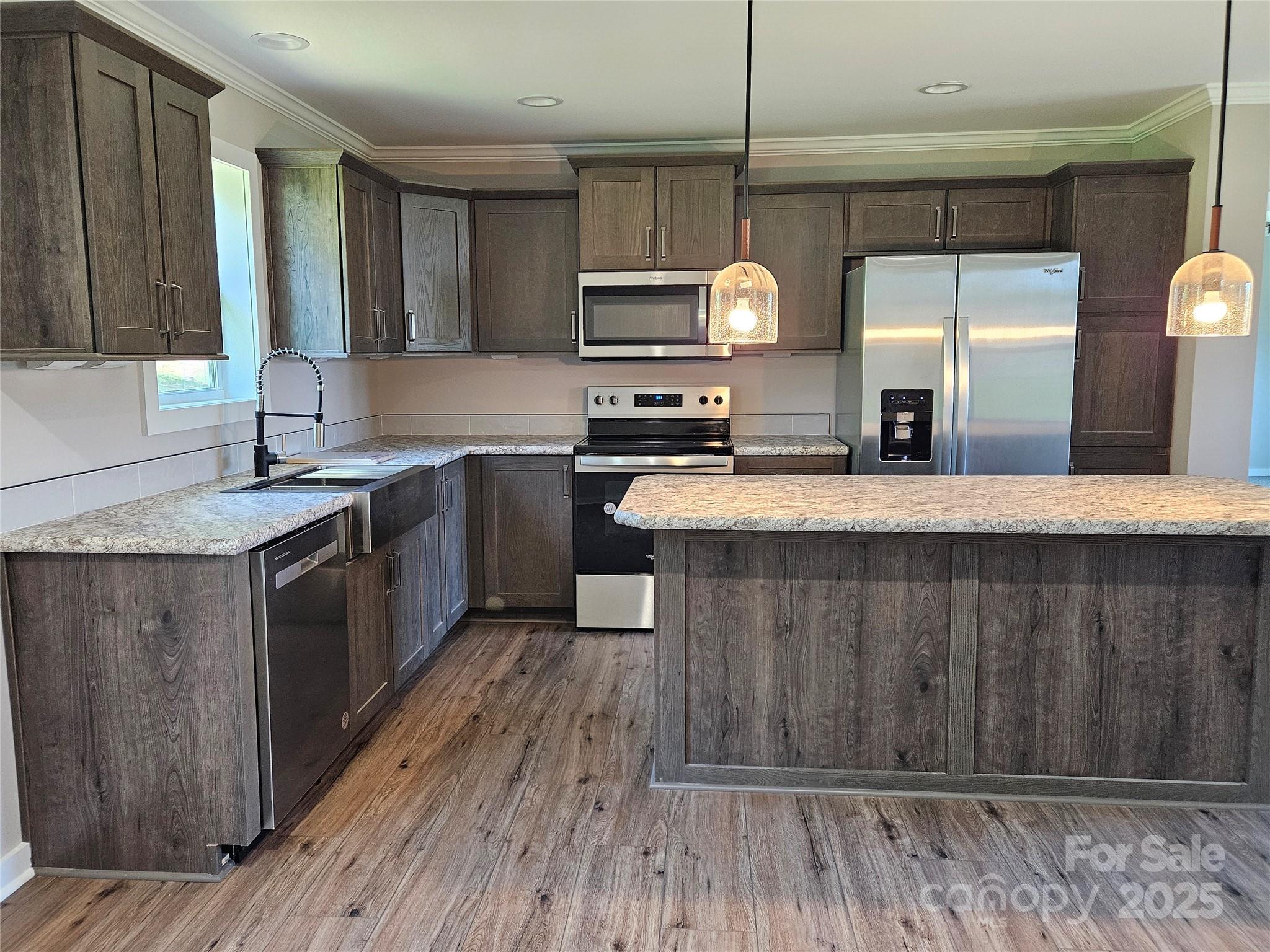 784 Severt Circle Lenoir, NC 28645 - Photo 11 of 41 a kitchen with stainless steel appliances granite countertop wooden cabinets a sink a stove a refrigerator and island
