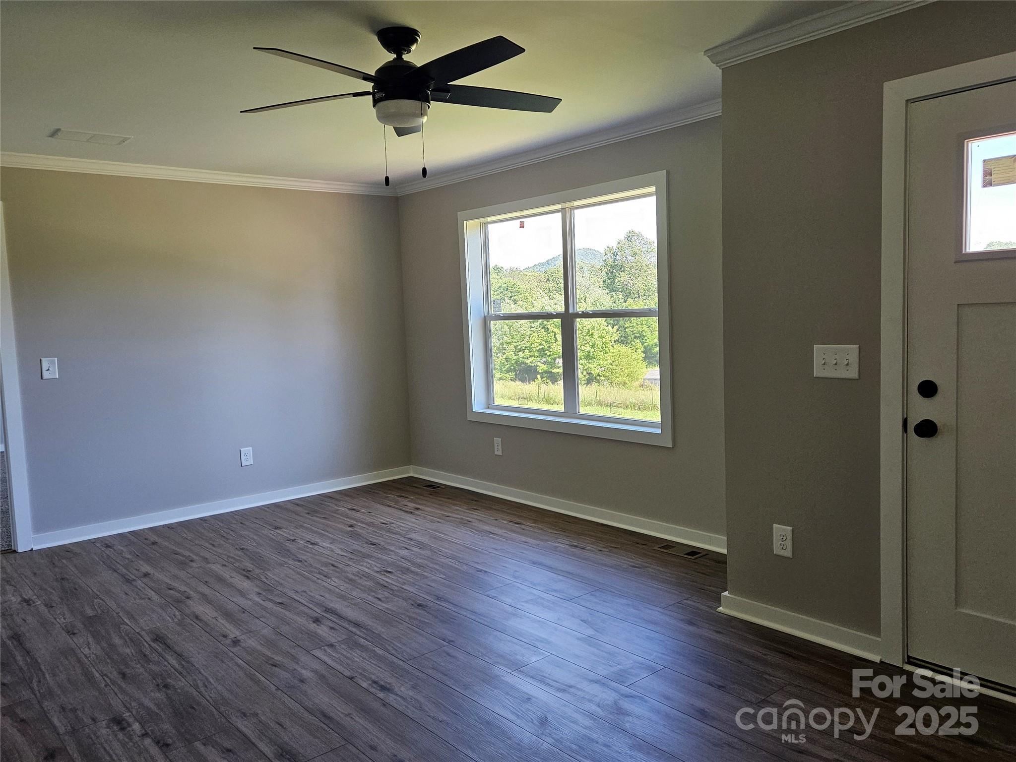 784 Severt Circle Lenoir, NC 28645 - Photo 9 of 41 a view of an empty room with wooden floor and a window