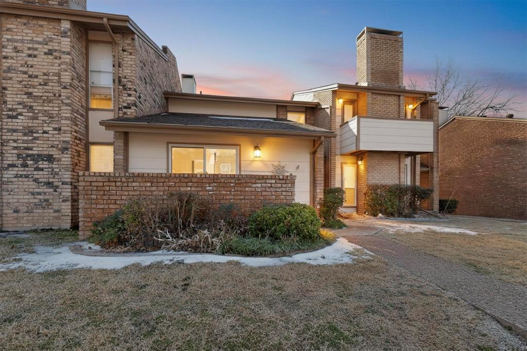 a view of a brick house with many windows
