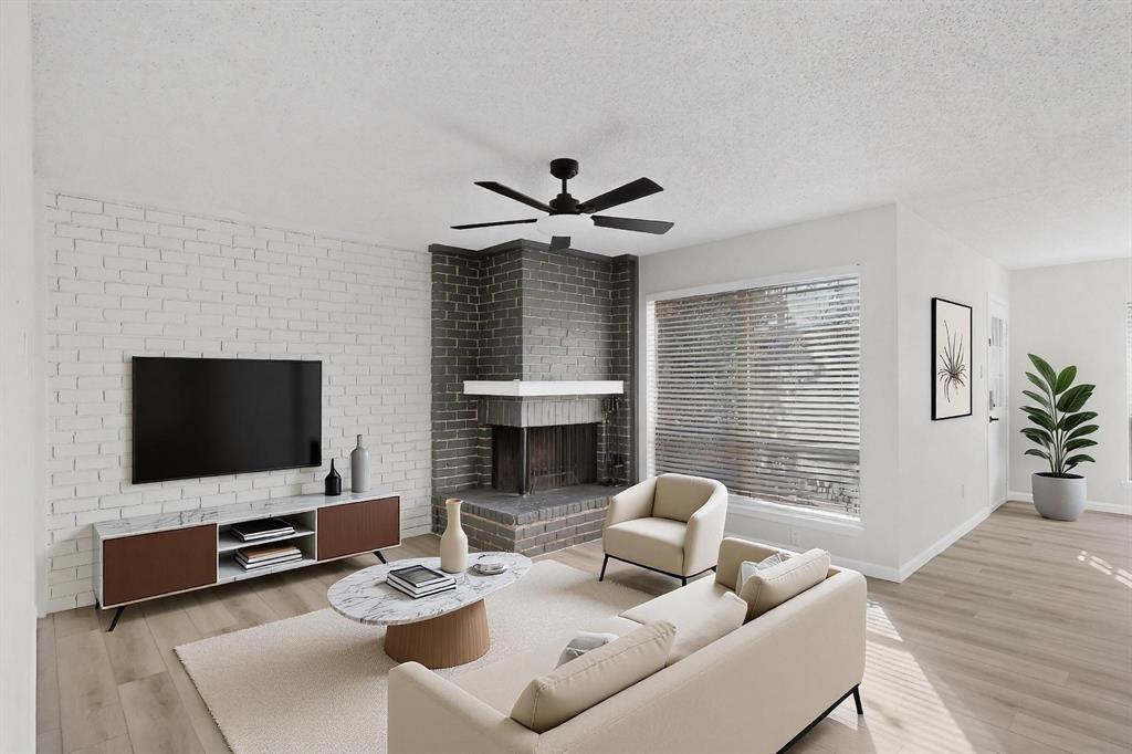 2018 Warnford Place Arlington, TX 76015 - Photo 3 of 34 a living room with furniture a fireplace and a flat screen tv