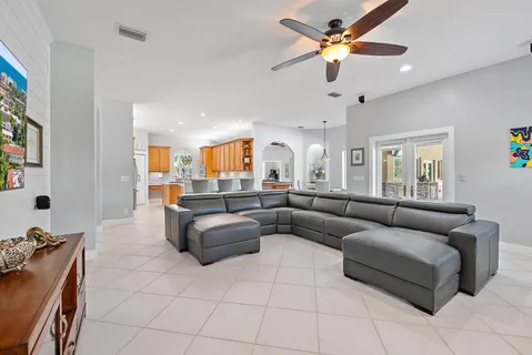 a living room with furniture and a chandelier