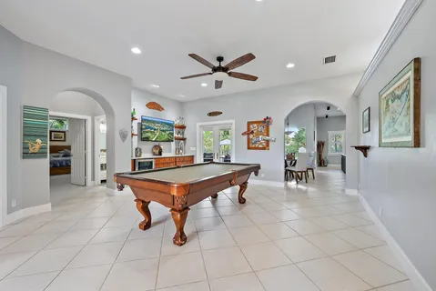 a living room with furniture a dining table and a large window