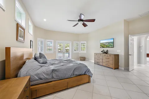 a bedroom with a bed and ceiling fan