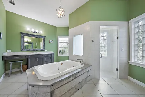 a bathroom with a sink a mirror and a bathtub