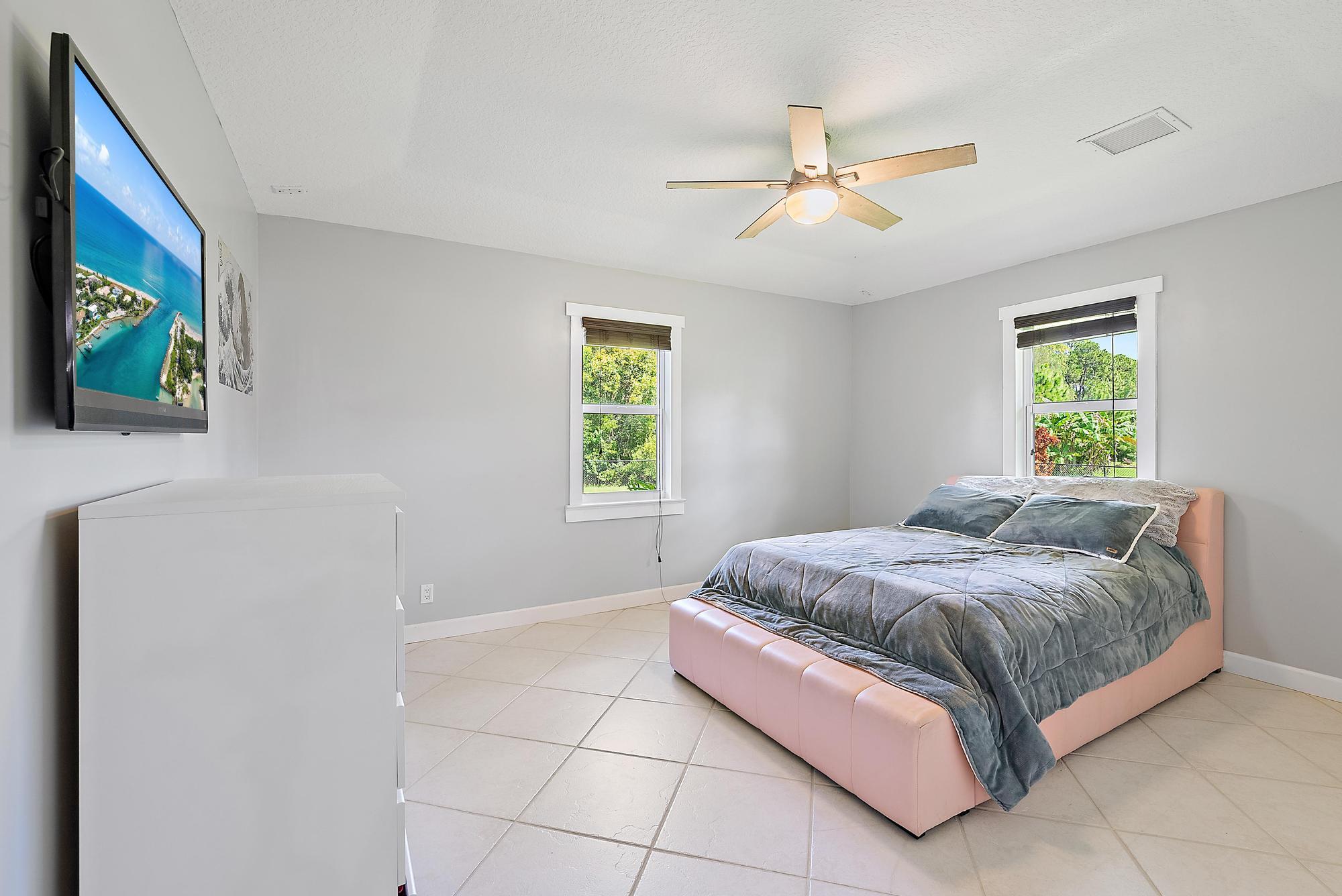 15847 86th Road North Loxahatchee, FL 33470 - Photo 18 of 45 a bedroom with a bed and a window