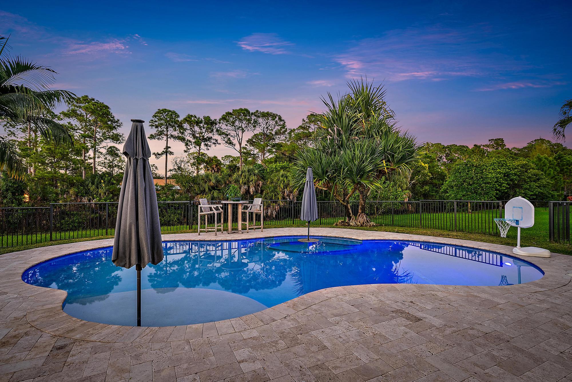 15847 86th Road North Loxahatchee, FL 33470 - Photo 2 of 45 a view of a swimming pool with a patio