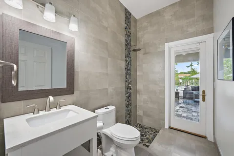 a bathroom with a sink a toilet and shower