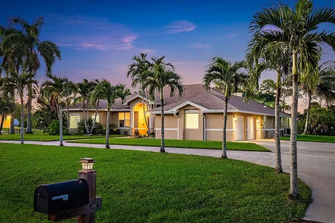 a front view of house with yard and green space