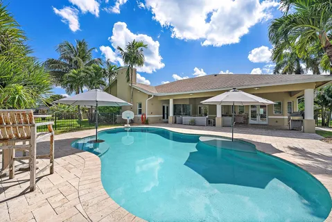 a house with swimming pool in front of it