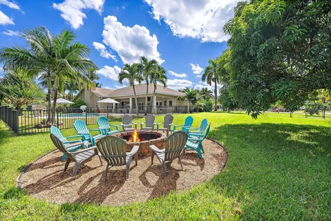 a view of a table and chairs in patio with a yard