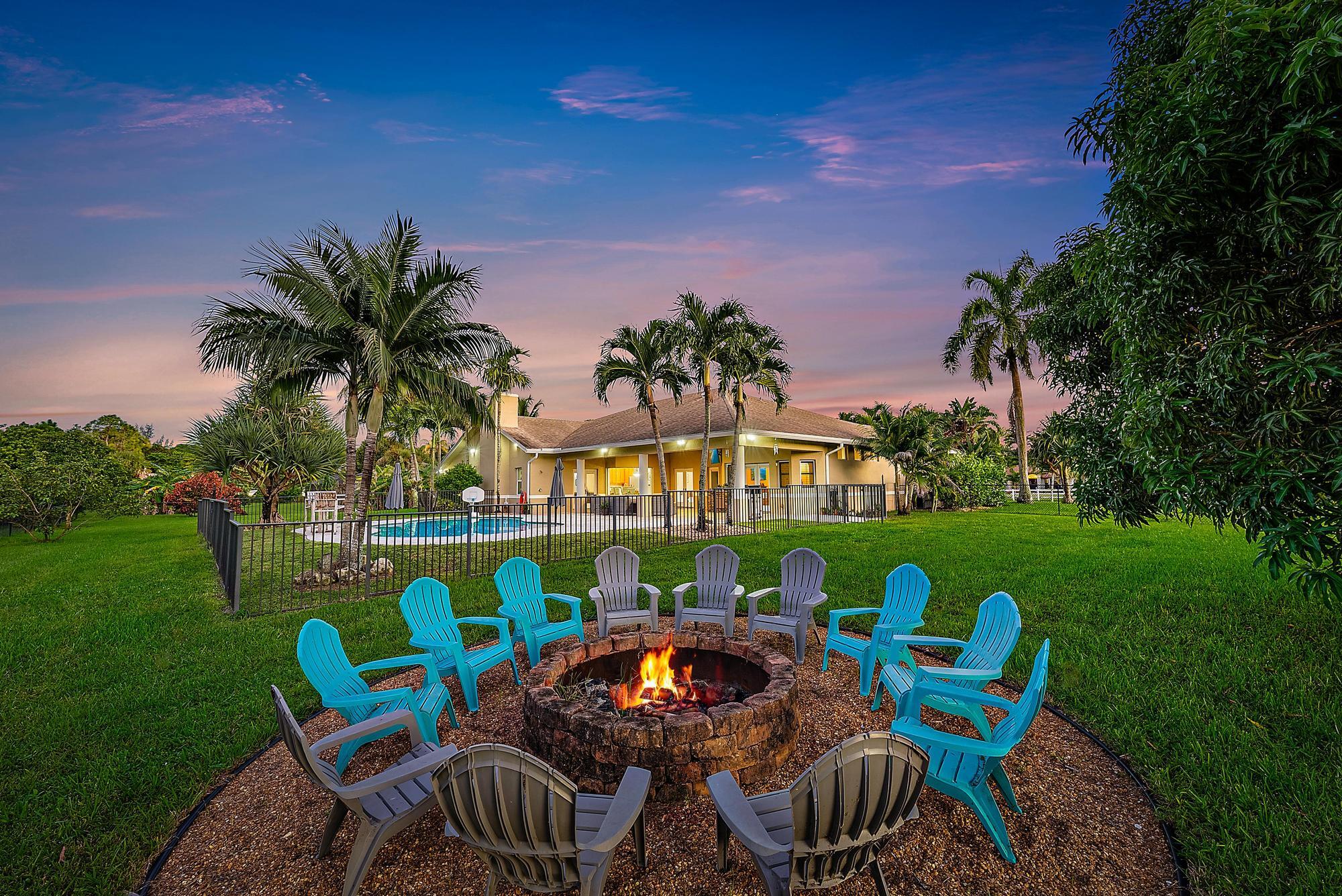 15847 86th Road North Loxahatchee, FL 33470 - Photo 4 of 45 a front view of a house with garden and patio