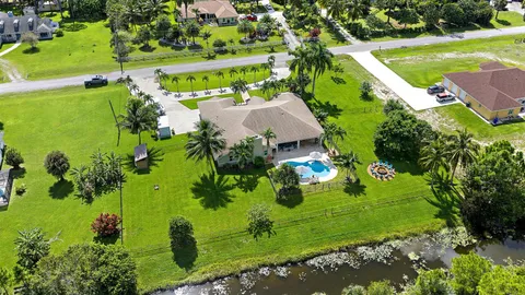 an aerial view of a golf course with parking space
