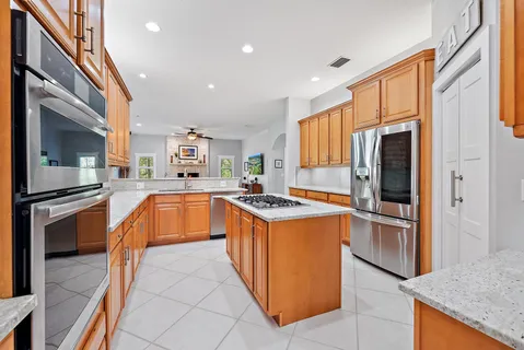 a kitchen with stainless steel appliances granite countertop a stove and a refrigerator