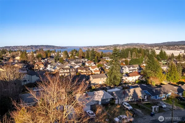 an aerial view of residential houses with outdoor space and swimming pool
