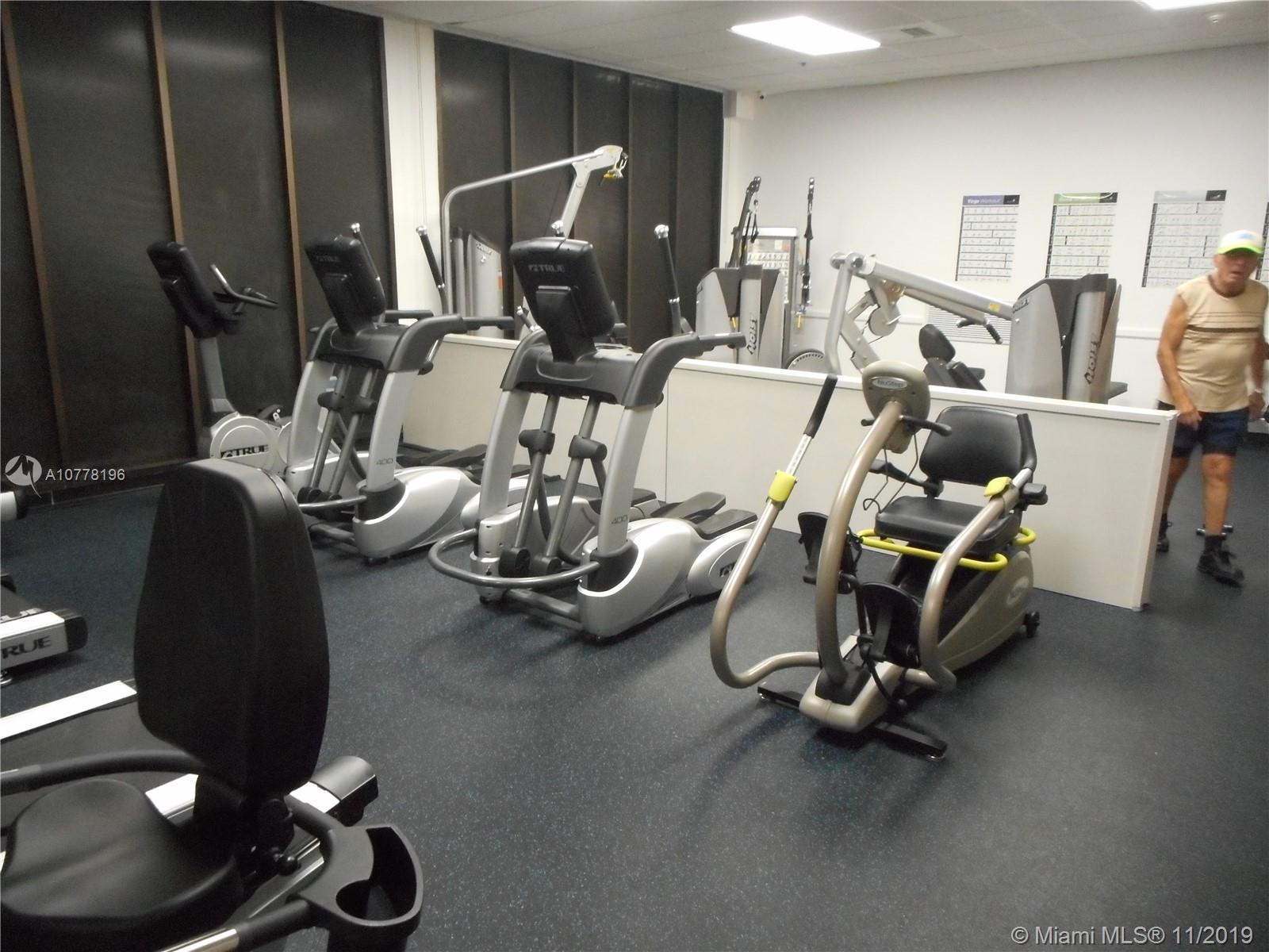9511 Collins Avenue, Unit 1209 Surfside, FL 33154 - Photo 14 of 20 a room with gym equipment