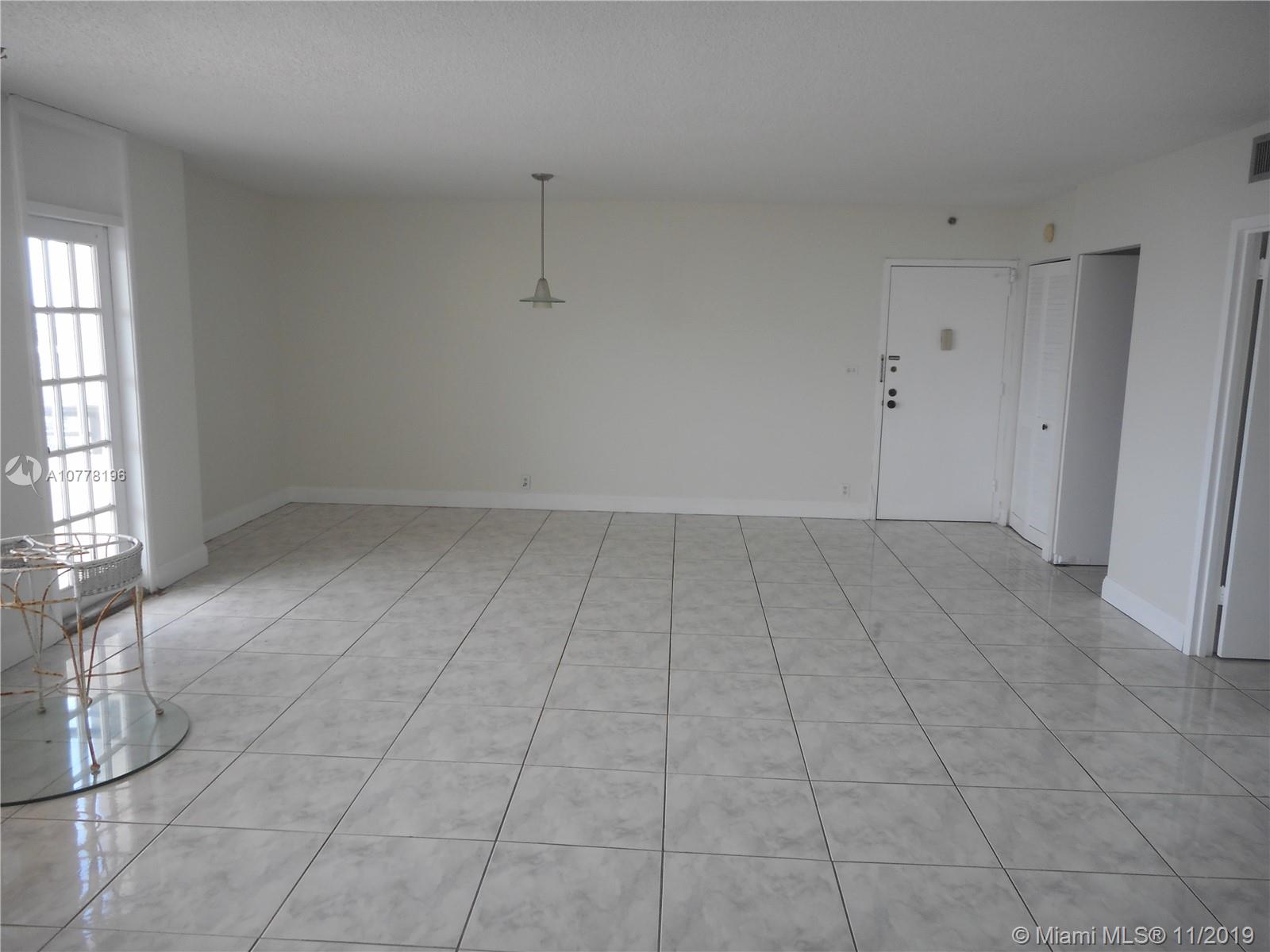 9511 Collins Avenue, Unit 1209 Surfside, FL 33154 - Photo 10 of 20 an empty room with white walls and windows