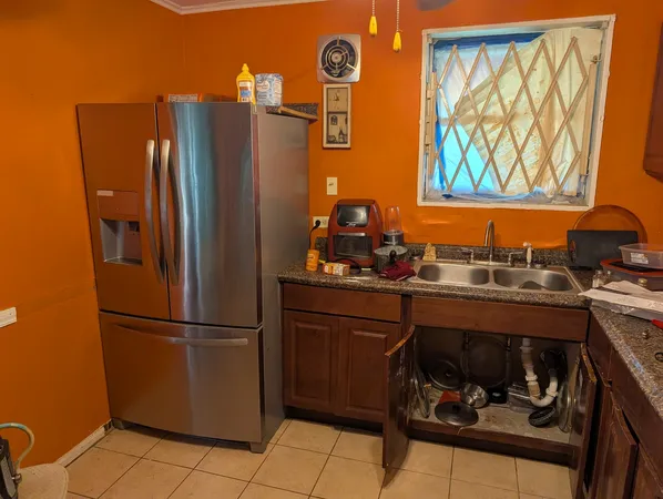 a kitchen with stainless steel appliances granite countertop a refrigerator and a stove