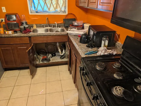 a stove top oven sitting inside of a kitchen