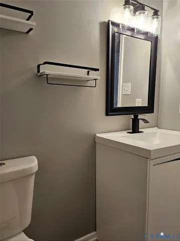 a bathroom with a sink a toilet and mirror