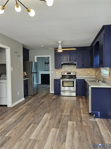 a kitchen with stainless steel appliances granite countertop a refrigerator oven a sink and dishwasher