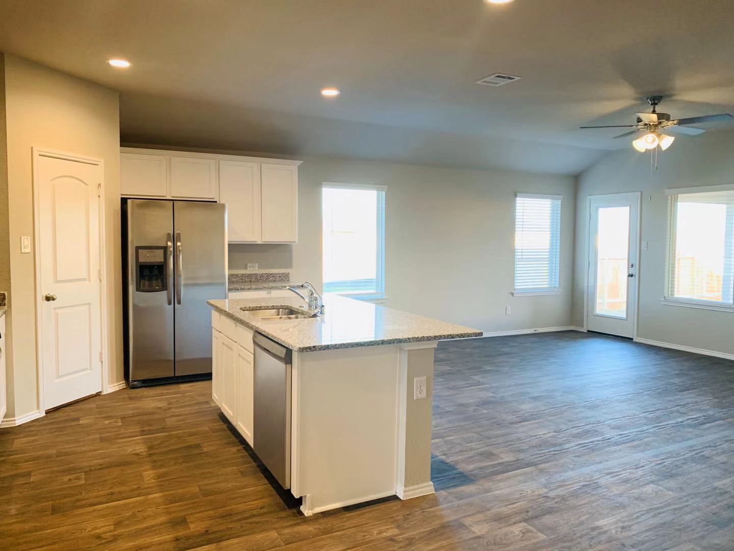 22730 Busalla Trail Katy, TX 77449 - Photo 6 of 10 a kitchen with granite countertop a refrigerator and a stove top oven