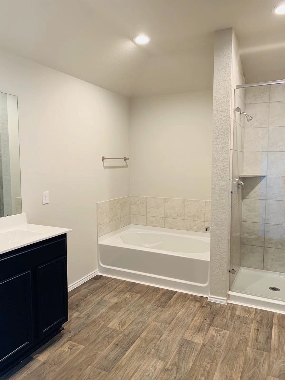 22730 Busalla Trail Katy, TX 77449 - Photo 7 of 10 a bathroom with a bathtub and a sink
