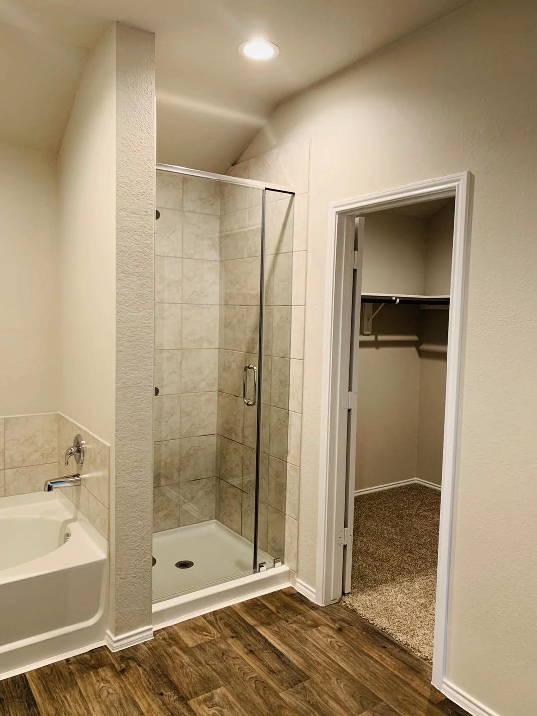 22730 Busalla Trail Katy, TX 77449 - Photo 9 of 10 a bathroom with a shower and a bathtub