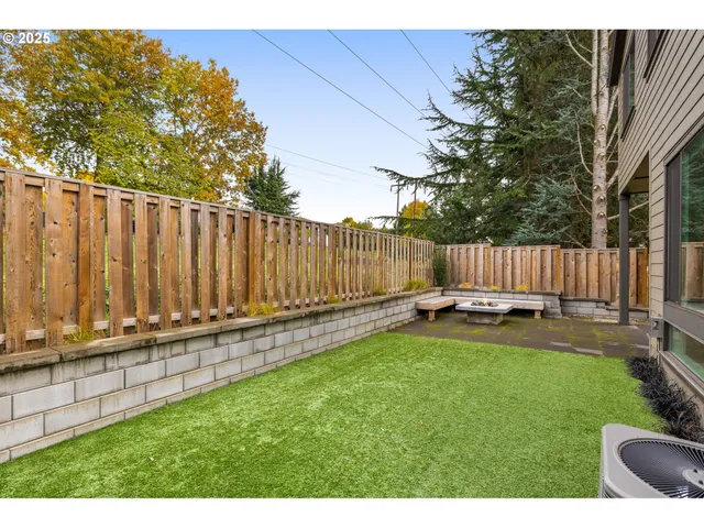 a view of a yard with sitting area and wooden fence