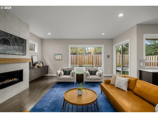 a living room with furniture a fireplace and a flat screen tv