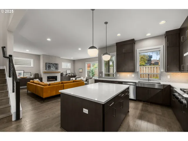 a kitchen with counter top space sink stove and refrigerator