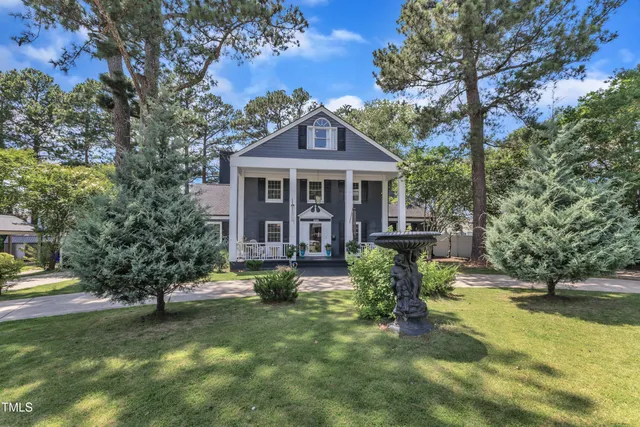 a view of a house with swimming pool and sitting area