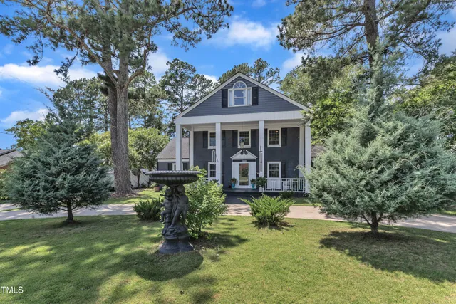 a front view of a house with a yard table and chairs