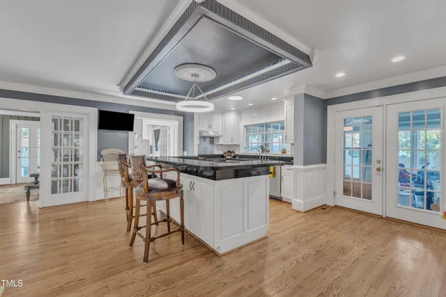 a view of a refrigerator in kitchen and wooden floor