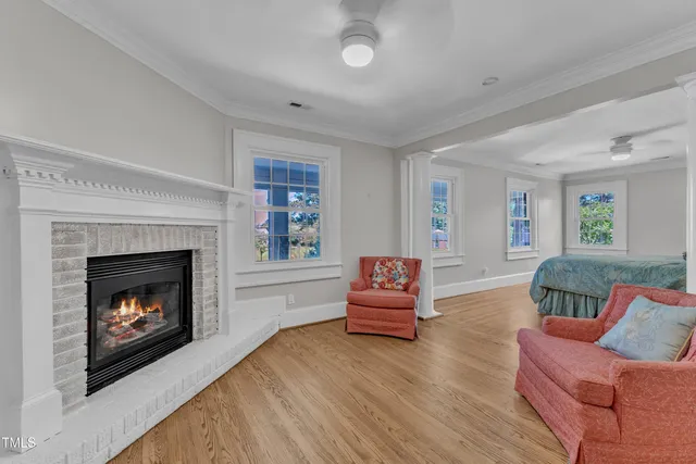 a view of a hallway with wooden floor and cabinet