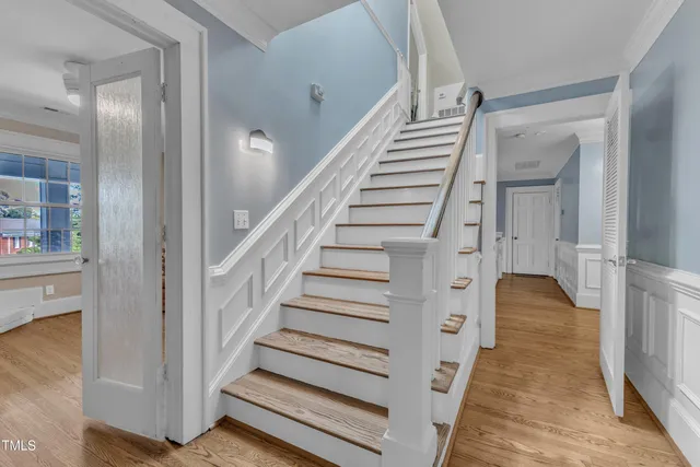 a bathroom with a granite countertop sink a toilet and a mirror