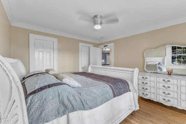 a view of a roof deck with couches and wooden fence