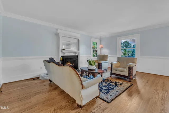 a living room with furniture wooden floor and a window