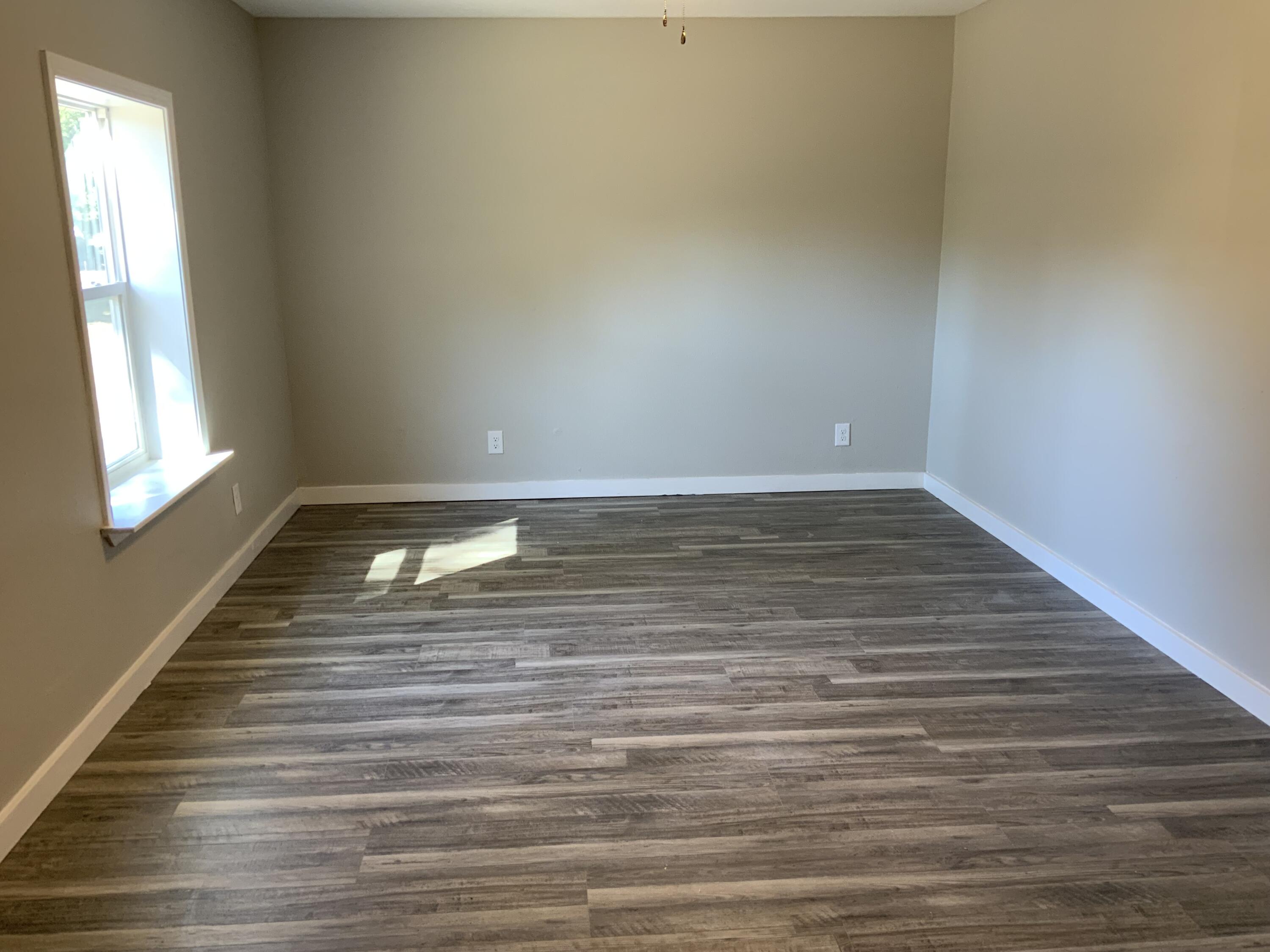 5847 Flamingo Road Crestview, FL 32539 - Photo 14 of 18 a view of wooden floor and windows in a room
