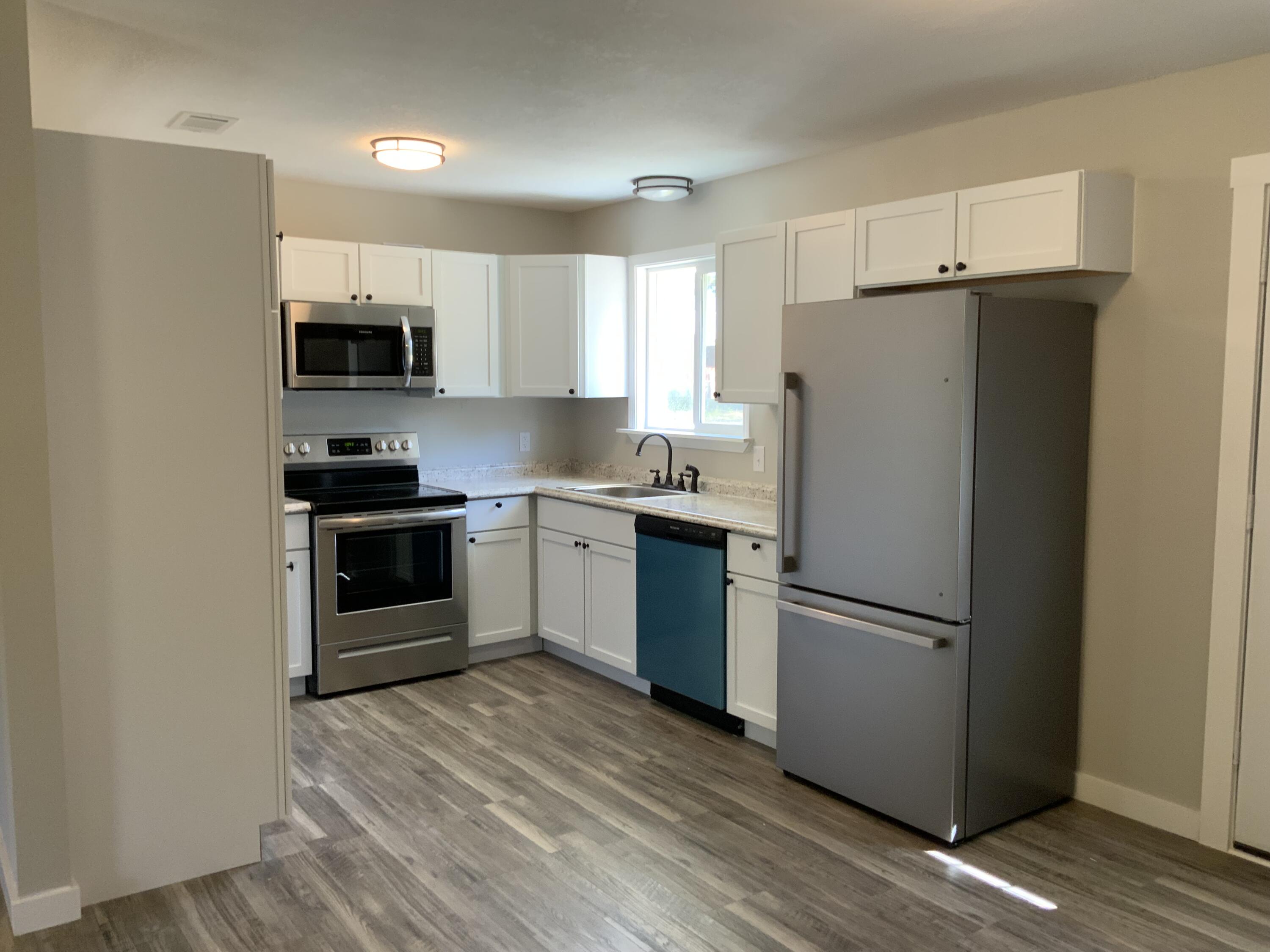 5847 Flamingo Road Crestview, FL 32539 - Photo 6 of 18 a kitchen with stainless steel appliances a refrigerator sink and microwave