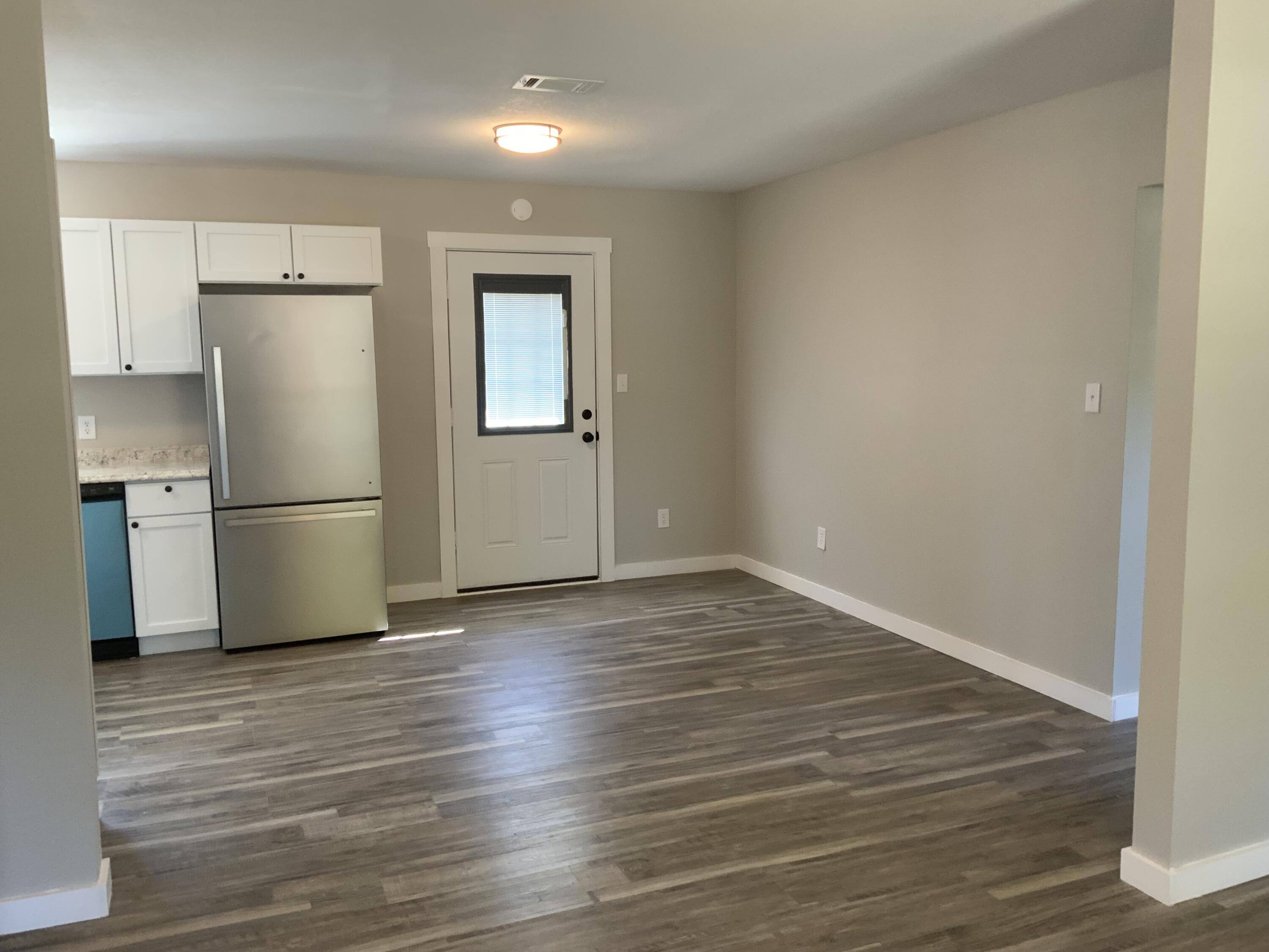 5847 Flamingo Road Crestview, FL 32539 - Photo 7 of 18 a view of a kitchen with wooden floor and a refrigerator