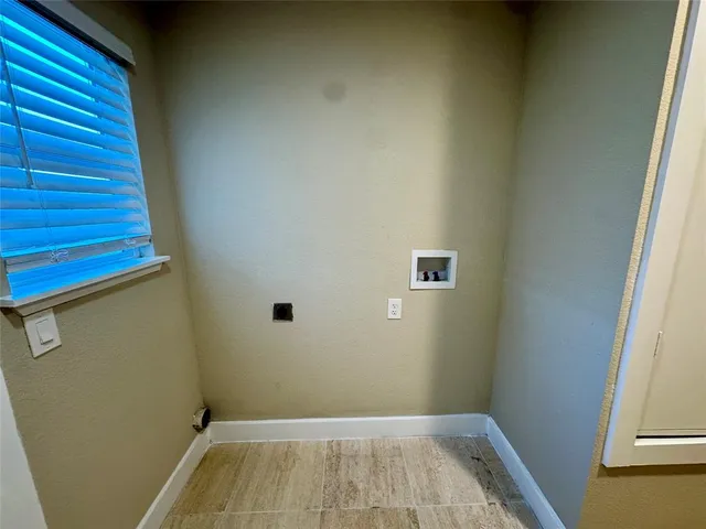 a view of a room with wooden floor and a window