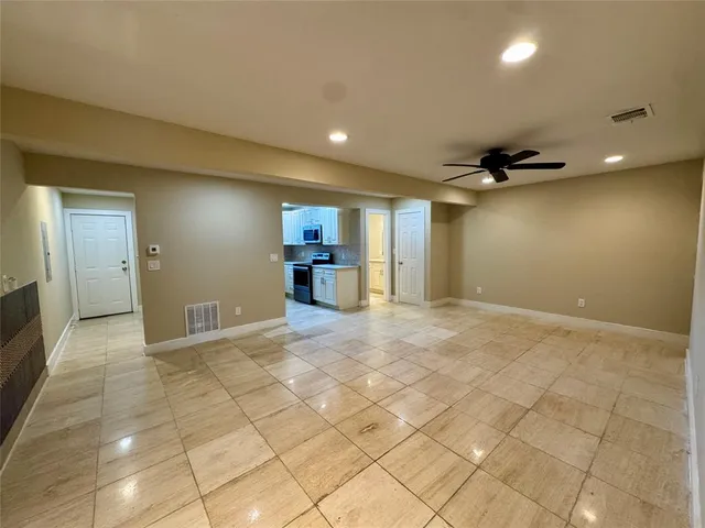 a view of a livingroom with furniture and an empty room