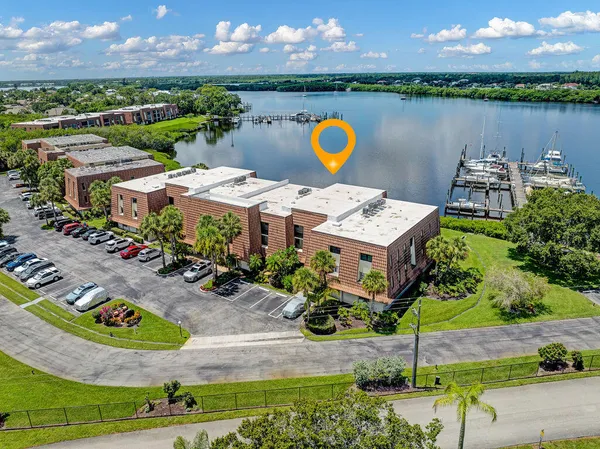 an aerial view of a house with outdoor space and lake view
